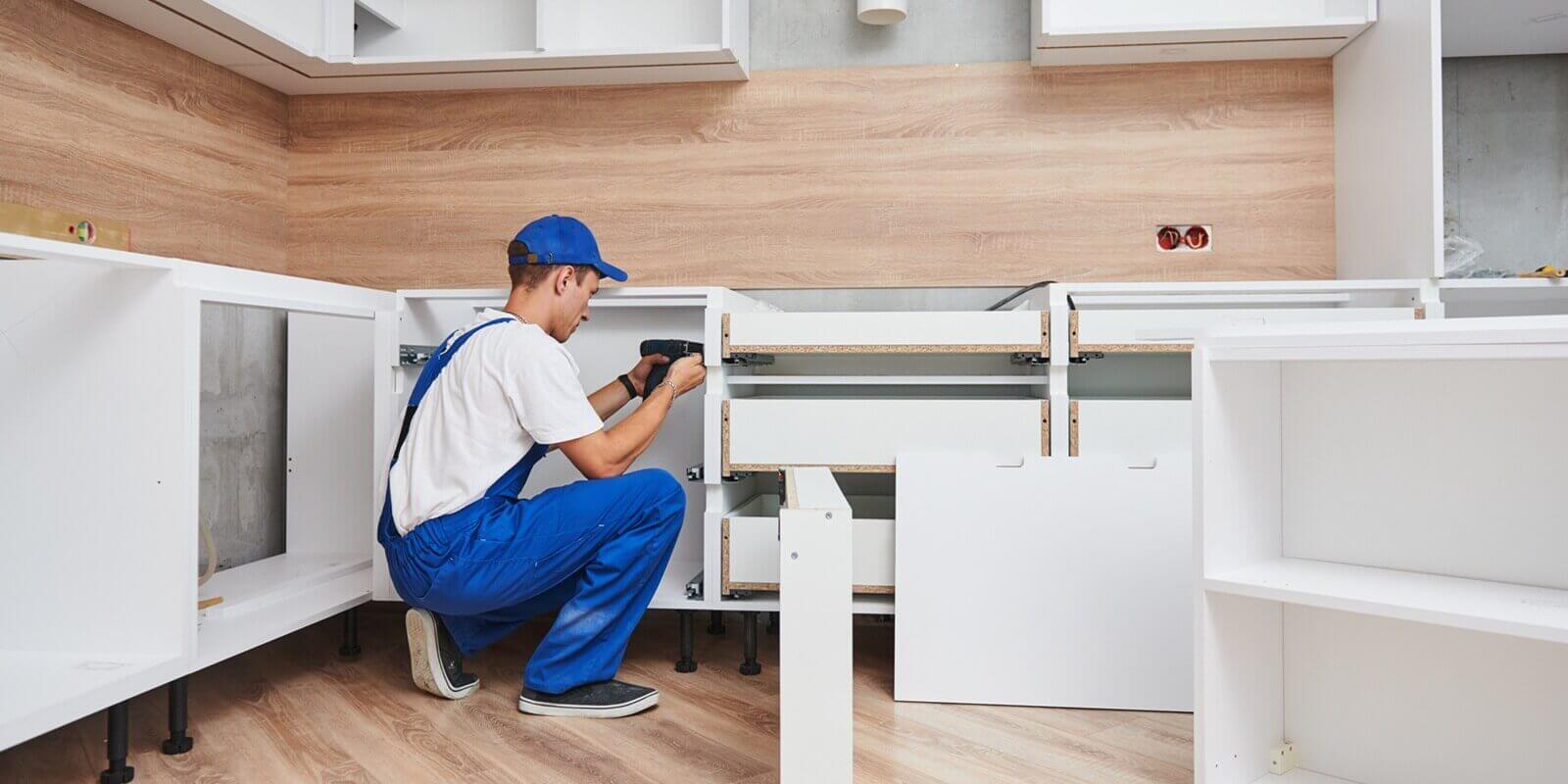 kitchen remodel installer assembling furniture