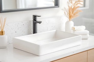 modern bathroom vanity with black faucet and white vessel sink