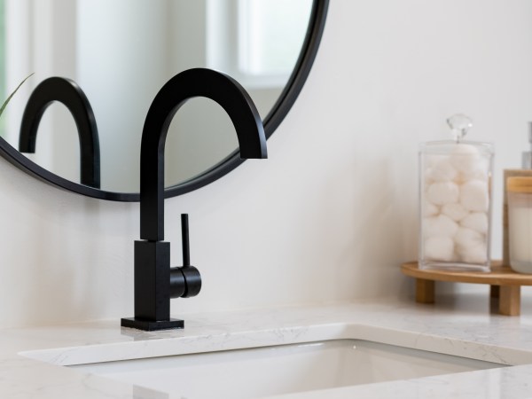 Modern bathroom details of sink with black faucet, black rim mir