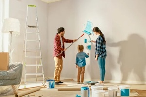 family repainting the wall