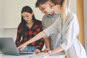 Designer Showing Kitchen Design to Clients in Laptop