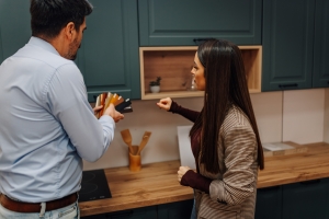 Client Choosing Kitchen Cabinet Colors for Remodeling with Designer